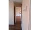 A hallway has neutral paint and laminate wood floors and leads to the main living area at 8221 12Th N Way # F, St Petersburg, FL 33702