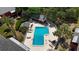 Aerial view of a community pool with lounge chairs, palm trees and a cabana at 8221 12Th N Way # F, St Petersburg, FL 33702