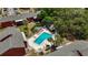 Aerial view of a community pool, featuring lounge chairs, palm trees and a cabana at 8221 12Th N Way # F, St Petersburg, FL 33702