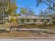 Street view of a single story home with light colored siding and a green front door and shutters at 679 Lake Maggiore S Blvd, St Petersburg, FL 33705