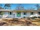 Charming home featuring a vibrant green door and matching shutters, complemented by well-maintained landscaping at 679 Lake Maggiore S Blvd, St Petersburg, FL 33705