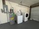 Washer and dryer hookups in the garage, located next to the water heater at 679 Lake Maggiore S Blvd, St Petersburg, FL 33705