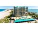 Aerial view of a condo building with beach access and parking at 1380 Gulf Blvd # 1008, Clearwater Beach, FL 33767