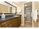 Clean bathroom with dark wood vanity, a large mirror, and shower/tub combo at 1380 Gulf Blvd # 1008, Clearwater Beach, FL 33767