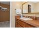 Bathroom with brown vanity and a large mirror at 1380 Gulf Blvd # 1008, Clearwater Beach, FL 33767