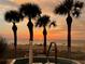 Stunning sunset view over the ocean, palm trees, and beach at 1380 Gulf Blvd # 1008, Clearwater Beach, FL 33767