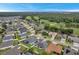 Aerial view of homes and golf course in the background at 3822 Salida Delsol Dr, Sun City Center, FL 33573