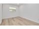 Simple bedroom with white walls and light wood floors at 7414 Van Dyke Rd, Odessa, FL 33556