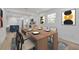 Elegant dining room with a long wooden table and modern kitchen view at 7414 Van Dyke Rd, Odessa, FL 33556