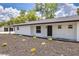 Modern white house with black accents and manicured landscaping at 7414 Van Dyke Rd, Odessa, FL 33556