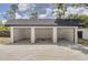 Three-car garage with white walls and black roof at 7414 Van Dyke Rd, Odessa, FL 33556
