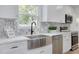 White shaker cabinets, farmhouse sink, and marble countertops at 7414 Van Dyke Rd, Odessa, FL 33556