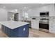 Spacious kitchen with a navy blue island and stainless steel appliances at 7414 Van Dyke Rd, Odessa, FL 33556