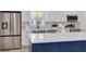 Modern kitchen boasts stainless steel appliances and a large island at 7414 Van Dyke Rd, Odessa, FL 33556