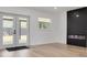 Living area featuring hardwood floors and a modern fireplace at 7414 Van Dyke Rd, Odessa, FL 33556