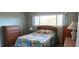 Bedroom with a double bed, dresser, night stand, and large windows at 2436 Rhodesian Dr # 42, Clearwater, FL 33763