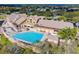 Aerial view showing clubhouse pool and surrounding landscape at 18602 Bent Pine Dr, Hudson, FL 34667