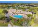 Aerial view of community clubhouse, pool, and golf course at 18602 Bent Pine Dr, Hudson, FL 34667