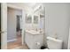 Clean bathroom with toilet, sink, and vanity at 18602 Bent Pine Dr, Hudson, FL 34667