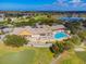 Community clubhouse with pool and surrounding landscape at 18602 Bent Pine Dr, Hudson, FL 34667