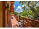 Home exterior showcasing a wooden deck overlooking a tranquil lake at 503 W Lutz Lake Fern Rd, Lutz, FL 33548