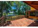 Wooden deck offering scenic views of a lake and lush greenery at 503 W Lutz Lake Fern Rd, Lutz, FL 33548