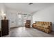 Living room with floral sofa and recliner, wood floors at 5396 Acacia N Trl, Pinellas Park, FL 33782