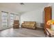 Living room with floral sofa and recliner, wood floors at 5396 Acacia N Trl, Pinellas Park, FL 33782