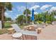 Relaxing pool area with lounge chairs, tables, and umbrellas at 5396 Acacia N Trl, Pinellas Park, FL 33782