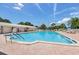 Community pool with surrounding lounge chairs and a poolside view at 5396 Acacia N Trl, Pinellas Park, FL 33782