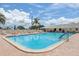 Inviting community swimming pool with brick decking and lounge chairs at 5396 Acacia N Trl, Pinellas Park, FL 33782