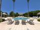 Resort-style pool with lounge chairs surrounded by lush landscaping and palm trees at 1180 Gulf Blvd # 2204, Clearwater Beach, FL 33767