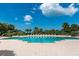 Large community pool surrounded by tropical landscaping and lounge chairs at 1180 Gulf Blvd # 2204, Clearwater Beach, FL 33767