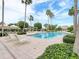 Outdoor pool area featuring lounge chairs, cabanas, and landscaping at 1180 Gulf Blvd # 2204, Clearwater Beach, FL 33767