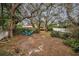 Large backyard with firepit and seating under shade trees at 335 Tucker St, Safety Harbor, FL 34695