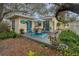 Enjoy outdoor dining on this deck with seating for four, under a striped umbrella at 335 Tucker St, Safety Harbor, FL 34695