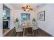 Modern dining room with table set for four and kitchen view at 335 Tucker St, Safety Harbor, FL 34695