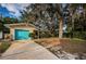 House exterior with teal garage door and driveway at 335 Tucker St, Safety Harbor, FL 34695