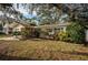 Ranch-style home with landscaped yard and teal accents at 335 Tucker St, Safety Harbor, FL 34695