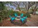 Relaxing firepit area with teal adirondack chairs at 335 Tucker St, Safety Harbor, FL 34695