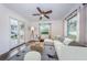 Bright living room with comfy furniture, hardwood floors, and French doors leading to a patio at 335 Tucker St, Safety Harbor, FL 34695