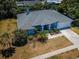 An aerial view of a home showing mature landscaping, a driveway, and a well-maintained lawn at 1032 Rosetree Ln, Tarpon Springs, FL 34689