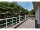 Wooden back deck overlooking lush greenery offers a private outdoor space at 1032 Rosetree Ln, Tarpon Springs, FL 34689