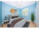Comfortable bedroom with a ceiling fan and a bright window at 1032 Rosetree Ln, Tarpon Springs, FL 34689