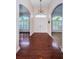 Bright foyer with gleaming hardwood floors, arched doorways, and stylish lighting at 1032 Rosetree Ln, Tarpon Springs, FL 34689