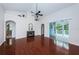 Spacious living room with high ceilings, hardwood floors, a fireplace, and sliding glass doors at 1032 Rosetree Ln, Tarpon Springs, FL 34689