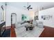 Bright living room with a fireplace, modern furniture, hardwood floors, and sliding glass doors at 1032 Rosetree Ln, Tarpon Springs, FL 34689