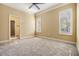 Spacious bedroom with neutral carpeting and large windows at 2983 Wentworth Way, Tarpon Springs, FL 34688