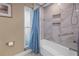 Bathroom with a tub and a patterned tile shower surround at 10073 S Yacht Club Dr, Treasure Island, FL 33706