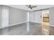 Bright bedroom with gray tile floors and a barn door to the bathroom at 10073 S Yacht Club Dr, Treasure Island, FL 33706